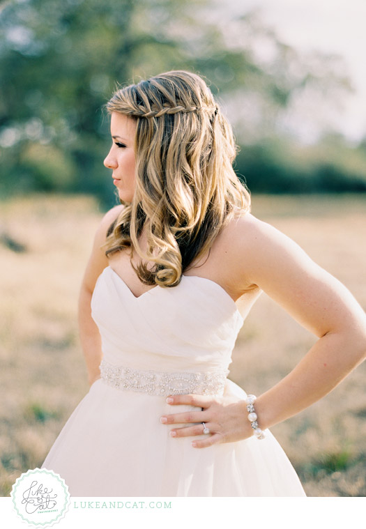 Sassy bride looks to the side with her hand on her hip.