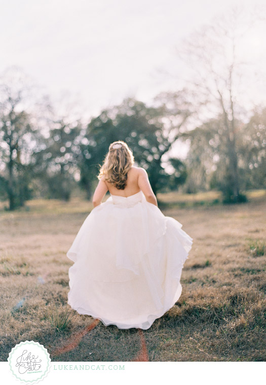 Bride holding her dress and walking away in the golden sunlight.